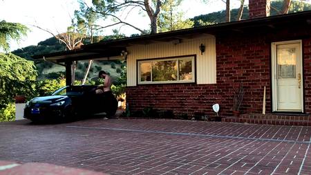 Наклонившаяся раком подруга дает себя драть возле спортивного автомобиля